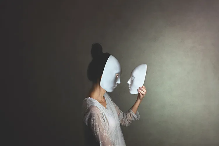 masked woman looking at a mask