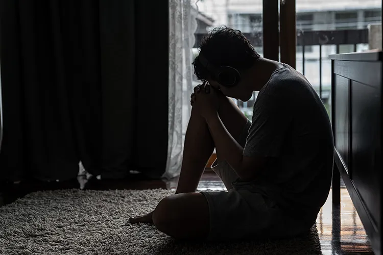 sad man sitting on the floor and crying