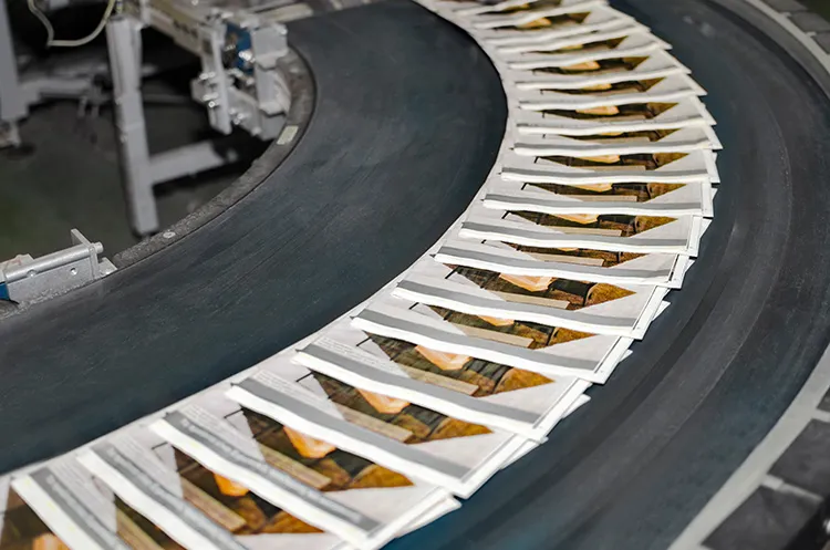 magazines on a conveyor belt