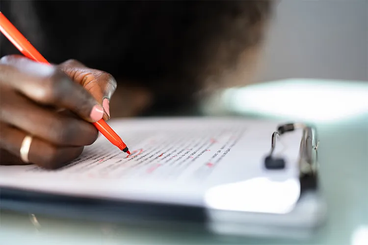 Using a red pen to edit a paper