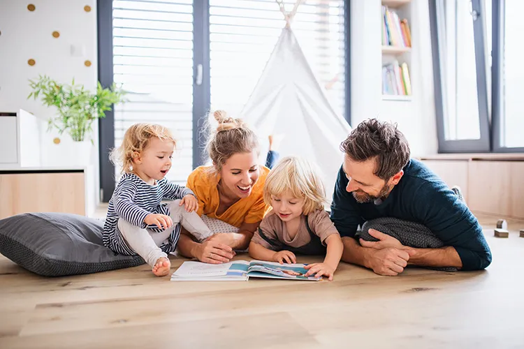 family of four reading a book
