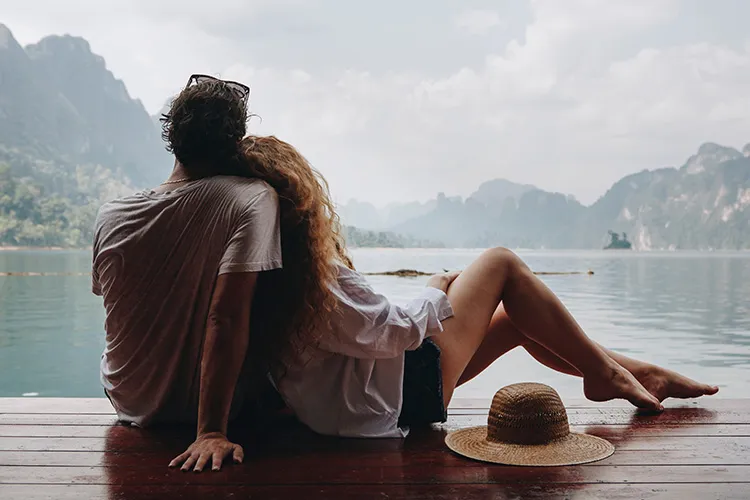 a couple looking at the water