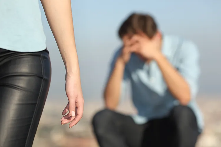 a woman walking away from her boyfriend