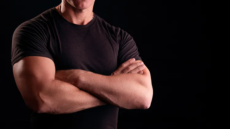 man with his muscular arms crossed