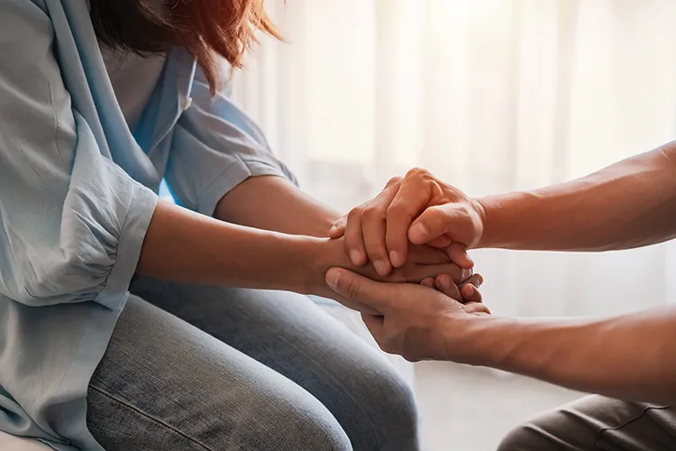 a man and woman clasp hands