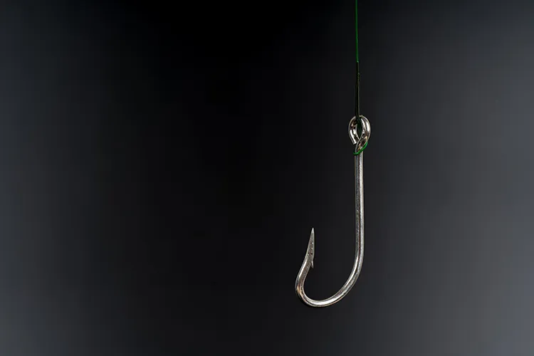 fishing hook against a black background