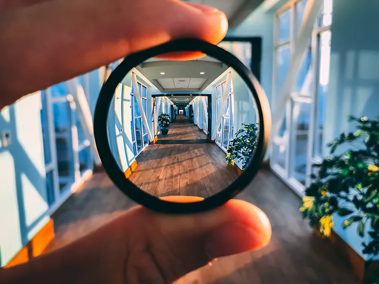 magnifying glass aimed at a long hallway