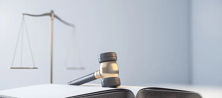 gavel, book, and scale in a court room