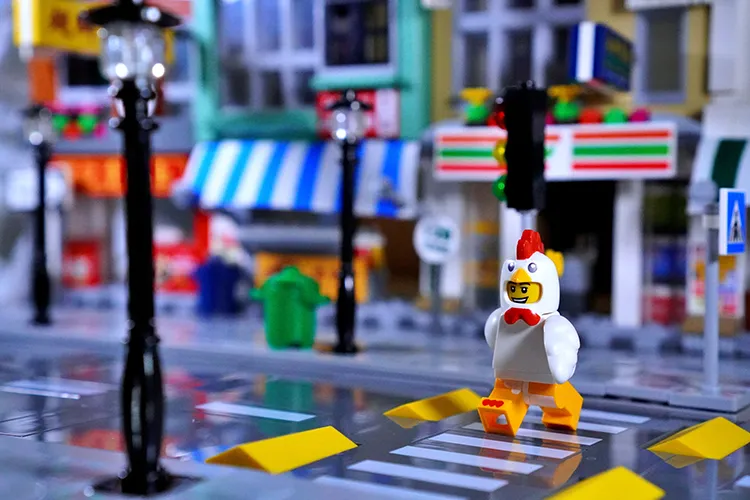 A Lego chicken man crossing the road