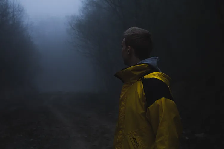 Man looking into the woods