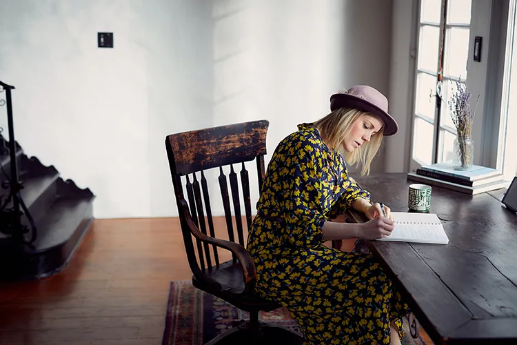 Woman writing at desk