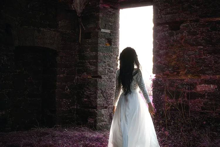 Woman walking through a magical door